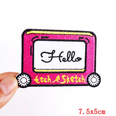 Patch with 'Hello' text and 'Litch Sketch' branding held by a hand on a white background