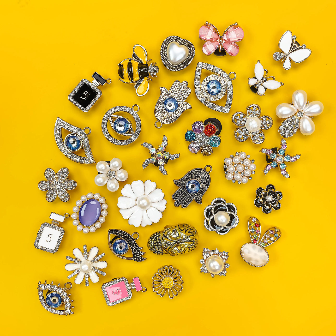 Collection of various shoe charms on a yellow background