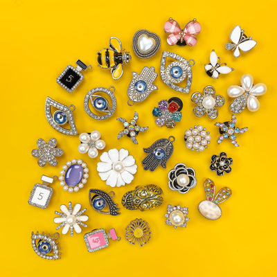 Collection of various shoe charms on a yellow background
