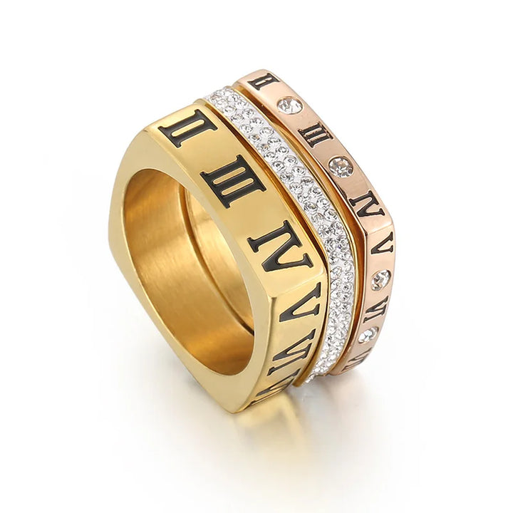 Gold ring with Roman numeral design on a white background