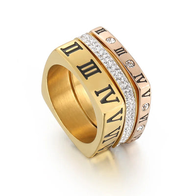 Gold ring with Roman numeral design on a white background