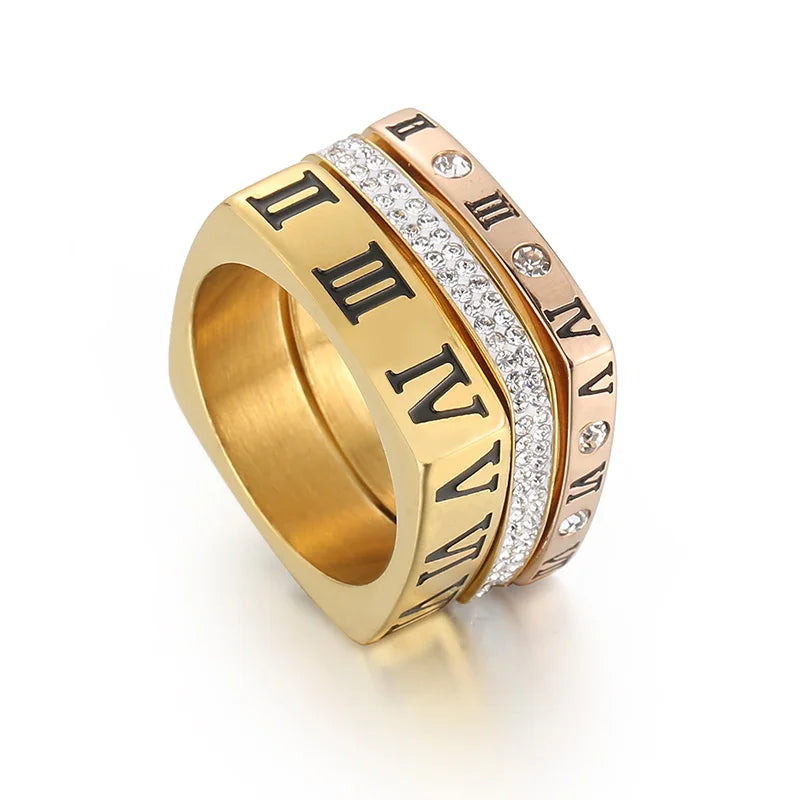 Gold ring with Roman numeral design on a white background