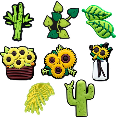 Set of green and yellow nature-themed shoe charms on a white background