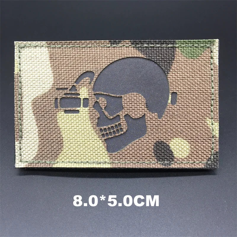 Camouflage patch with skull and helmet design on a dark background