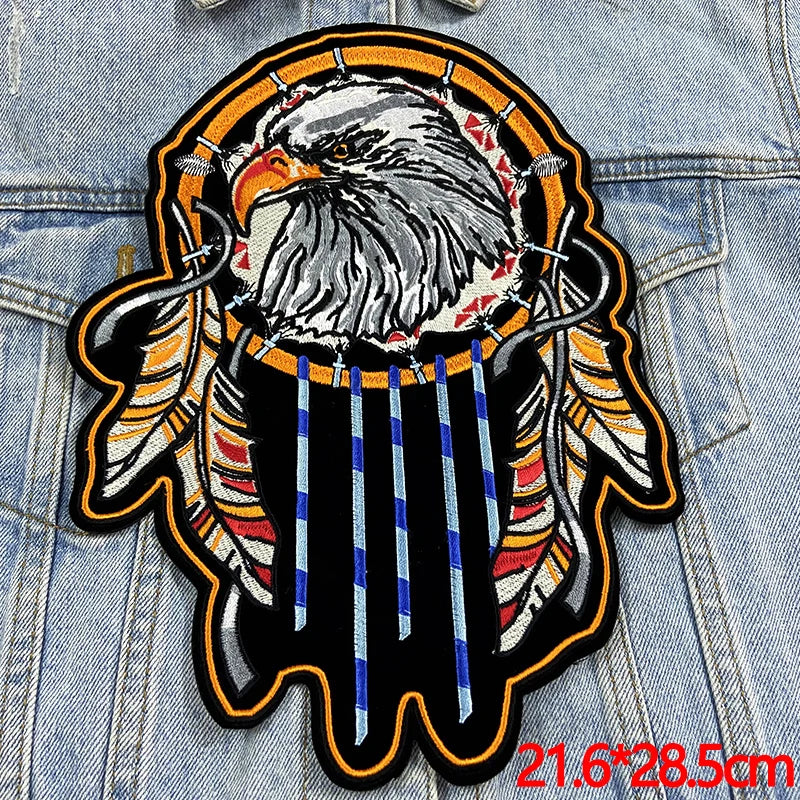 Decorative patch with an eagle and dreamcatcher design on denim fabric.