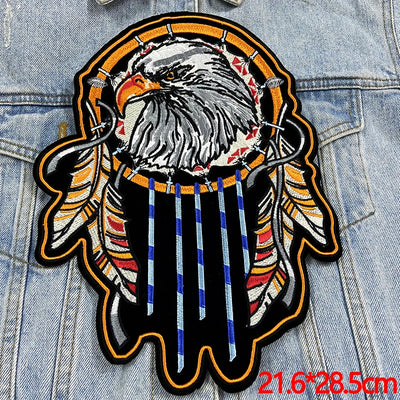 Decorative patch with an eagle and dreamcatcher design on denim fabric.