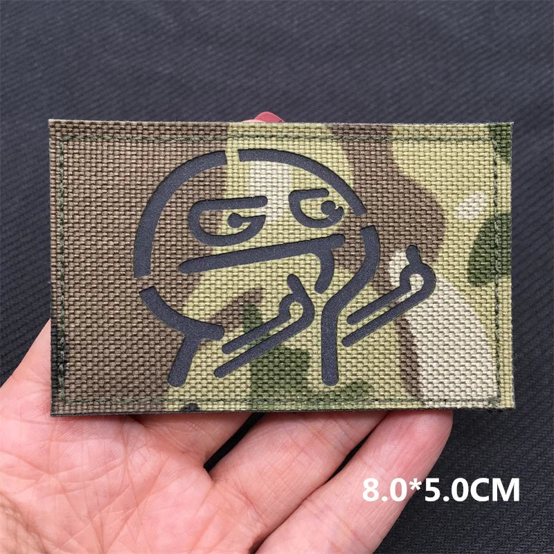Molotov cocktail patch on a camouflage background held in a hand