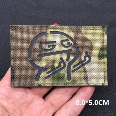Molotov cocktail patch on a camouflage background held in a hand