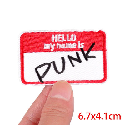 Name tag patch with 'HELLO my name is PUNK' text held by a hand, on a white background.