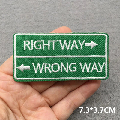 Embroidered patch with 'Right Way' and 'Wrong Way' text held in a hand against a gray background.