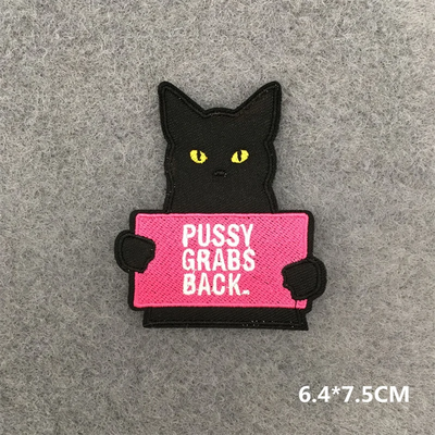 Black cat holding a pink sign with text on a gray background