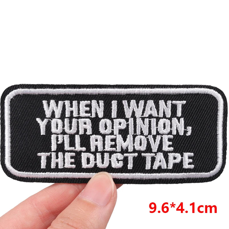Embroidered patch with text 'When I want your opinion, I'll remove the duct tape' held by a hand on a white background.