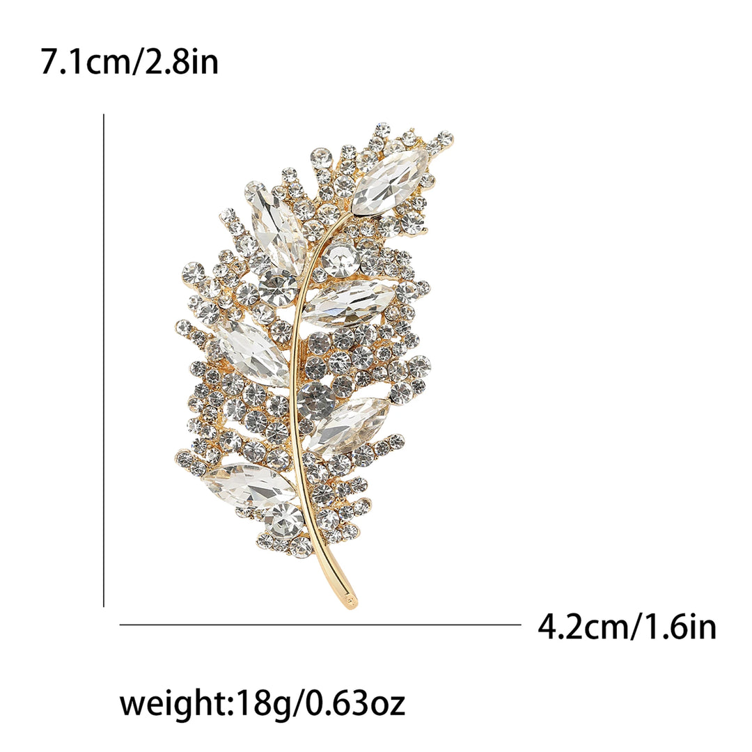 Gold and crystal leaf-shaped brooch with measurements and weight displayed.