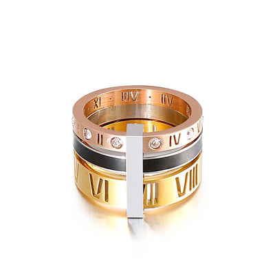 Gold and rose gold ring with Roman numeral design on a white background