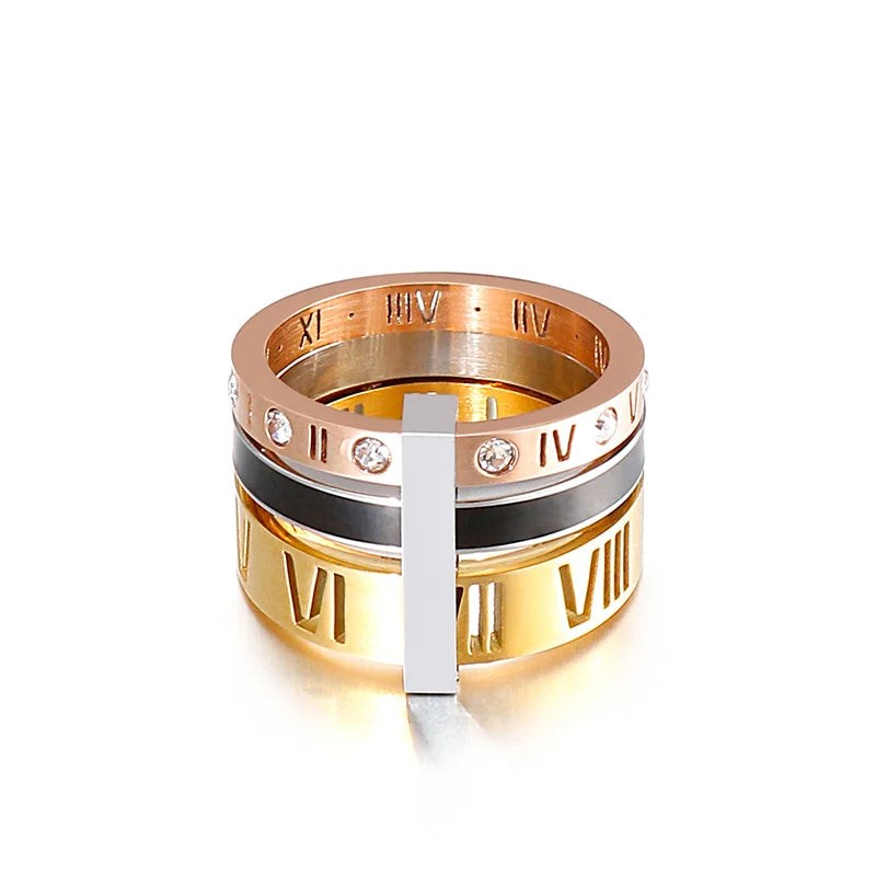 Gold and rose gold ring with Roman numeral design on a white background