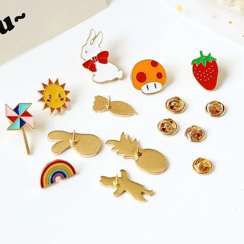 Collection of colorful and gold-themed pins on a white background