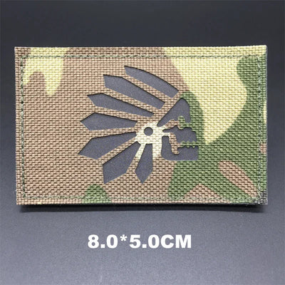 Camouflage patch with a gray floral design on a dark background