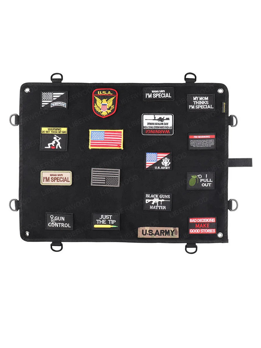 Black patch panel with various patches including U.S. Army and American flags on a white background