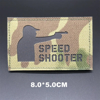Camouflage patch with 'Speed Shooter' text and silhouette on a dark background