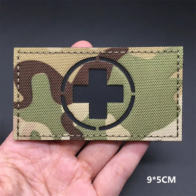 Switzerland flag Camouflage patch  held in a hand against a dark background