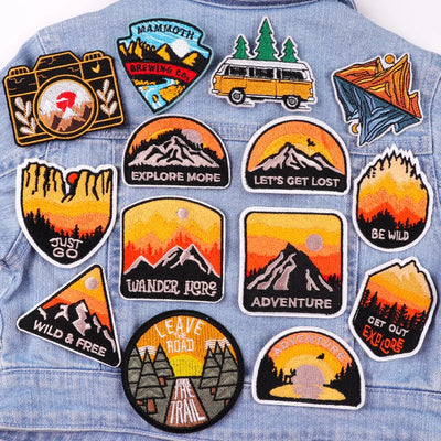 Collection of outdoor-themed patches on a denim jacket