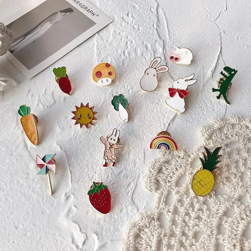 Collection of colorful enamel pins on a textured white surface with a photo frame in the background.