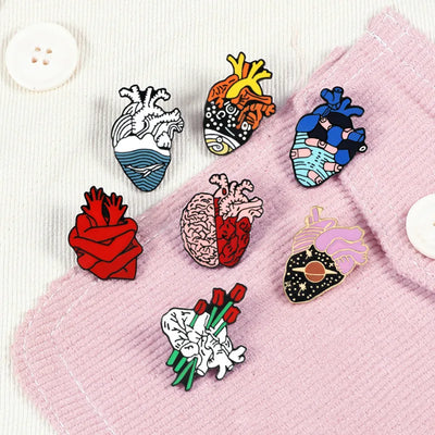Set of colorful pins on a pink fabric background