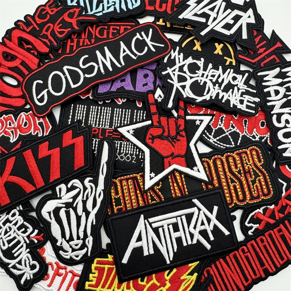 Collection of music band patches including Godsmack, Slayer, Kiss, and Anthrax.