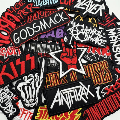Collection of music band patches including Godsmack, Slayer, Kiss, and Anthrax.