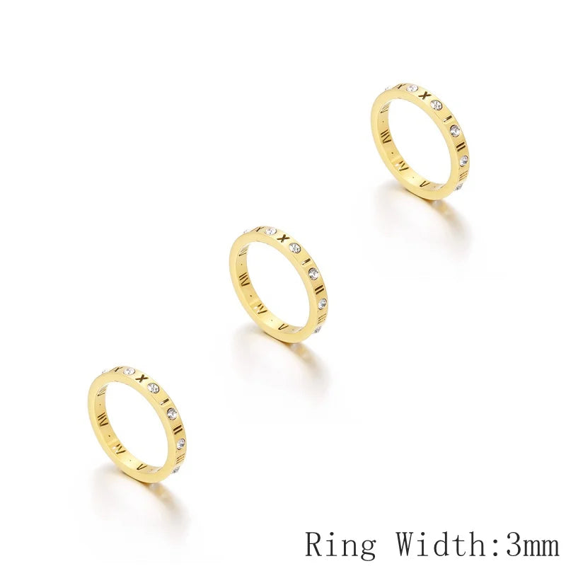 Three gold rings with small diamonds on a white background, labeled &