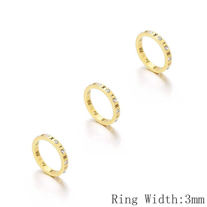 Three gold rings with small diamonds on a white background, labeled &