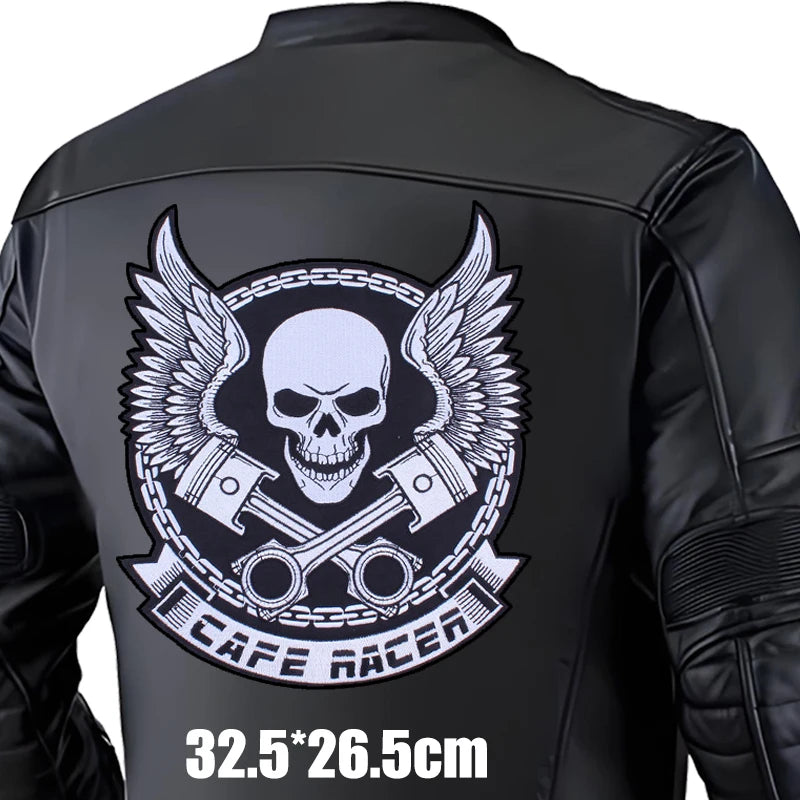 Black leather jacket with a skull and wings design on the back, featuring the brand 'Cafe Racer'.