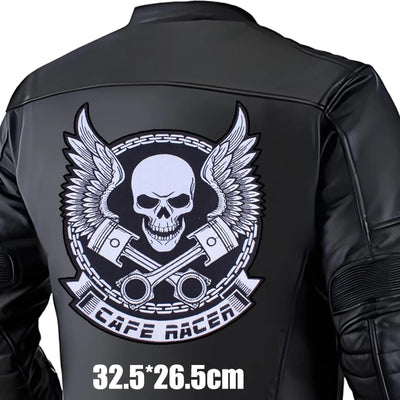 Black leather jacket with a skull and wings design on the back, featuring the brand 'Cafe Racer'.