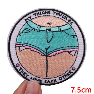 Patch with cartoon illustration of underwear and text, held by a hand with measurement label.