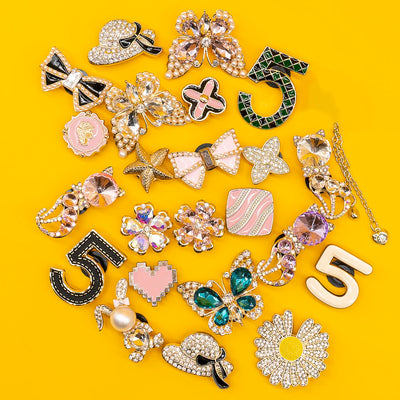 Collection of decorative shoe charms on a yellow background