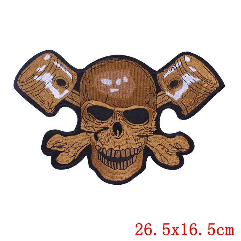 Skull and crossbones patch with crossed pistons on a white background, featuring the brand &