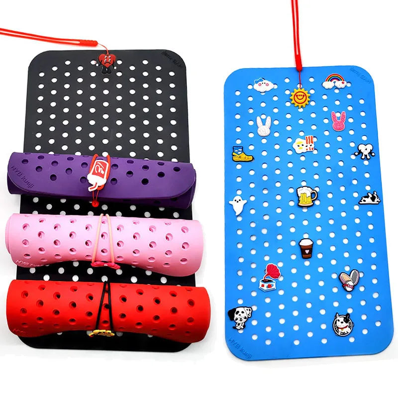 Colorful pegboards with various items on a white background