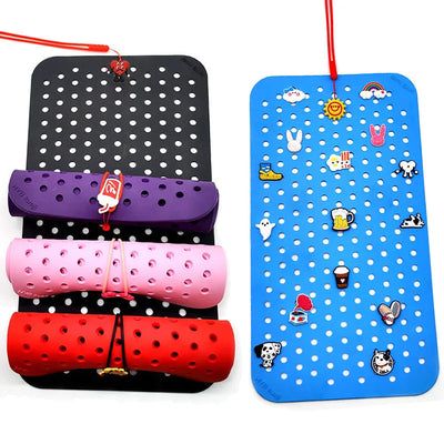 Colorful pegboards with various items on a white background