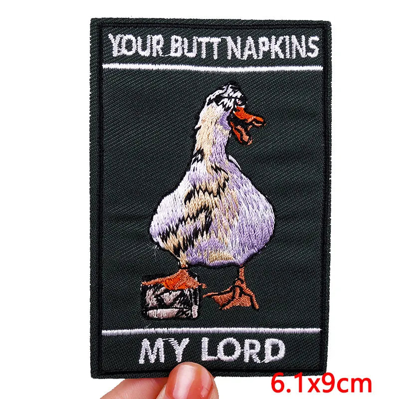 Embroidered patch with a duck and text on a black background