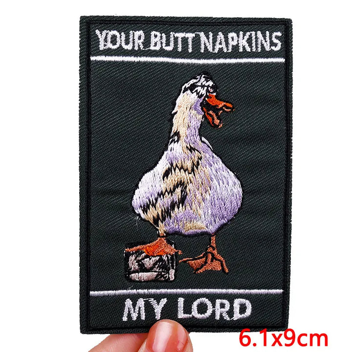 Embroidered patch with a duck and text on a black background