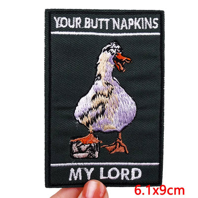 Embroidered patch with a duck and text on a black background