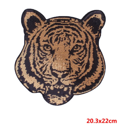 Tiger head patch with black and gold design on a white background