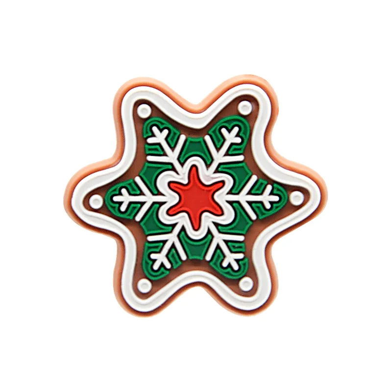 Shoe charm ornament of Decorative star-shaped cookie with green, red, and white icing on a white background