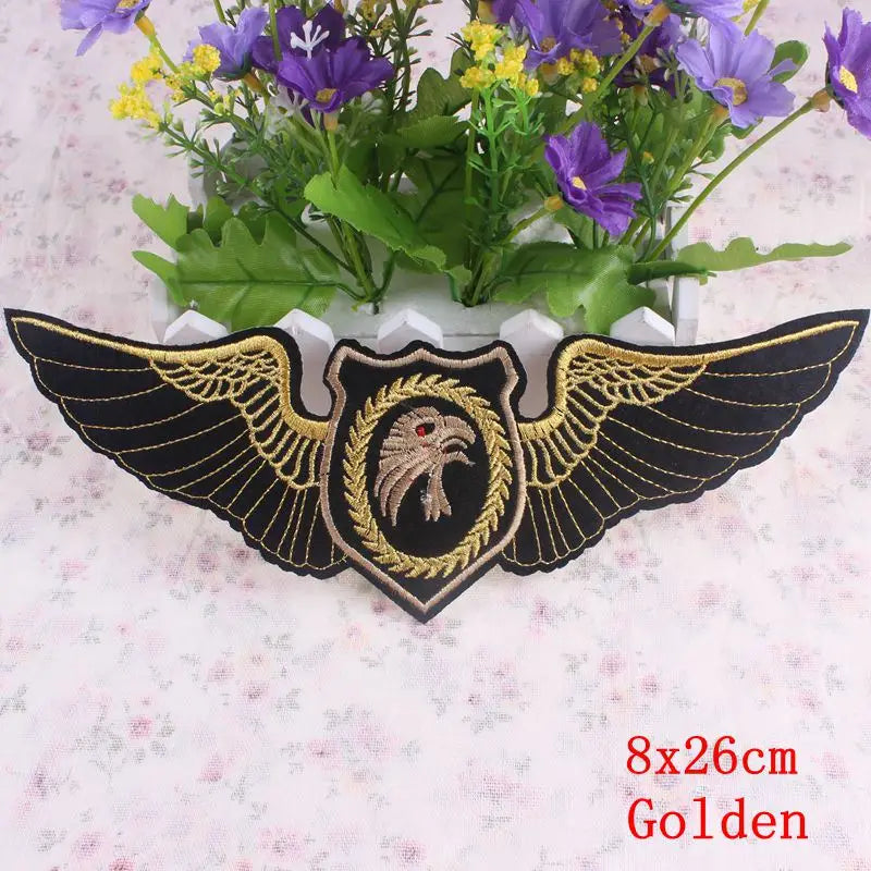 Embroidered patch with eagle design and wings on a floral background