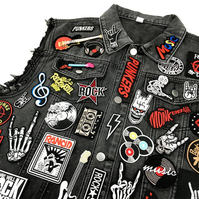 Black denim jacket with various colorful patches on a white background