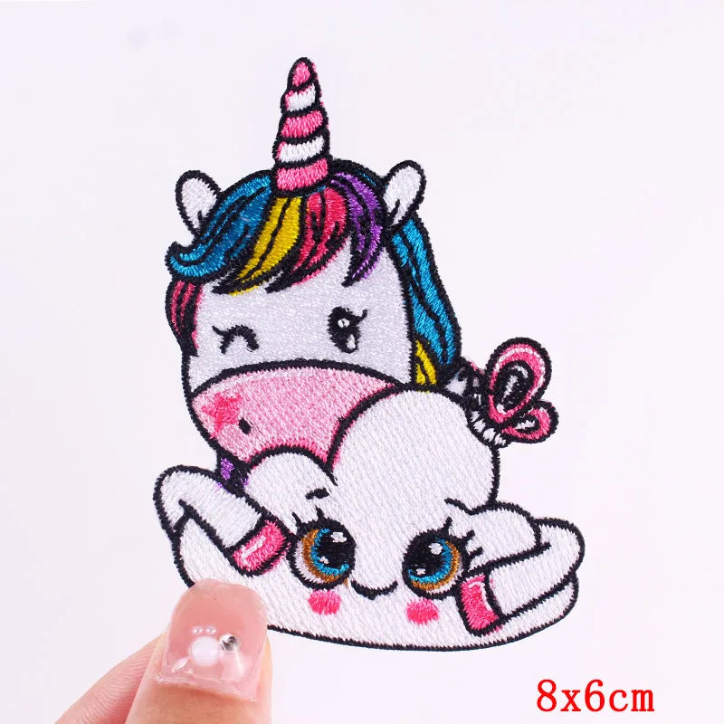 Embroidered patch of a cartoon unicorn and cat on a white background