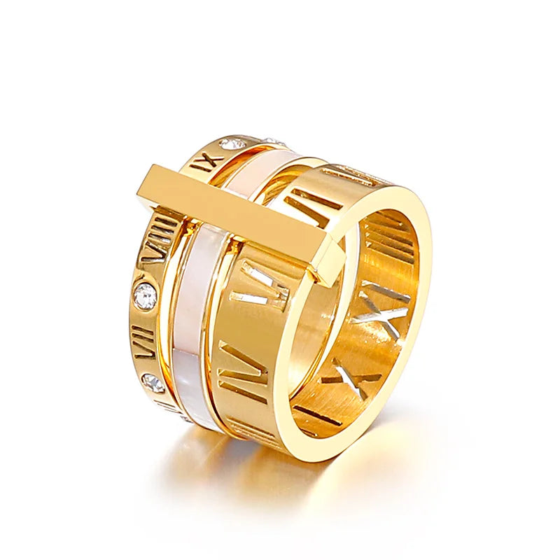 Gold ring with intricate design on a white background