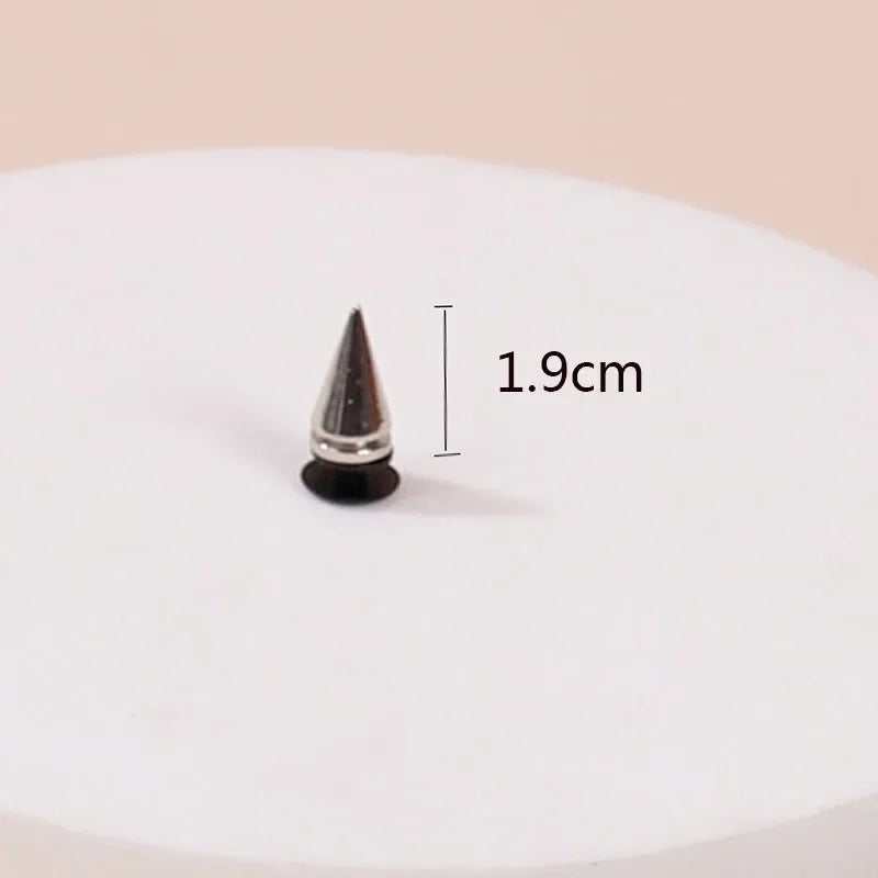 Black spike with measurement label on a white plate