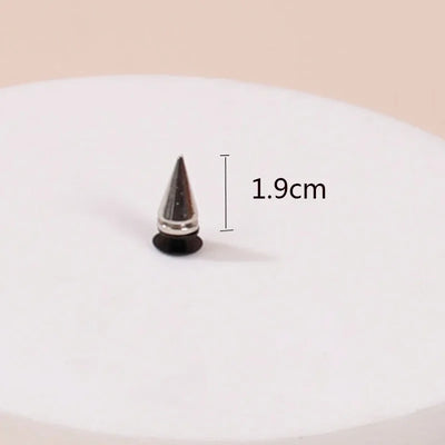 Black spike with measurement label on a white plate