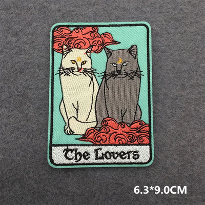 Embroidered patch of 'The Lovers' tarot card with two cats on a dark gray background.